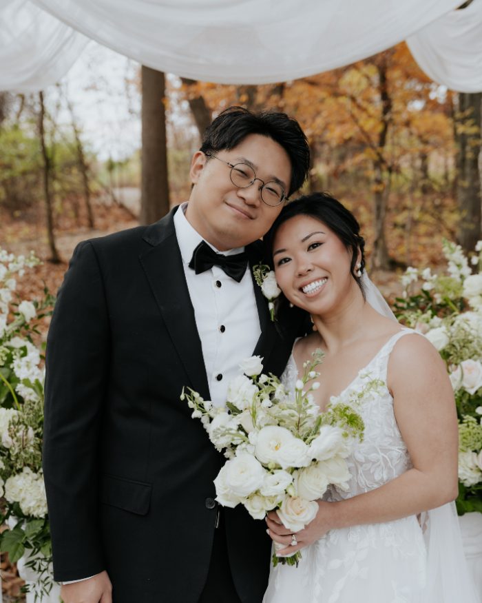 Newlyweds at their autumn ceremony arch